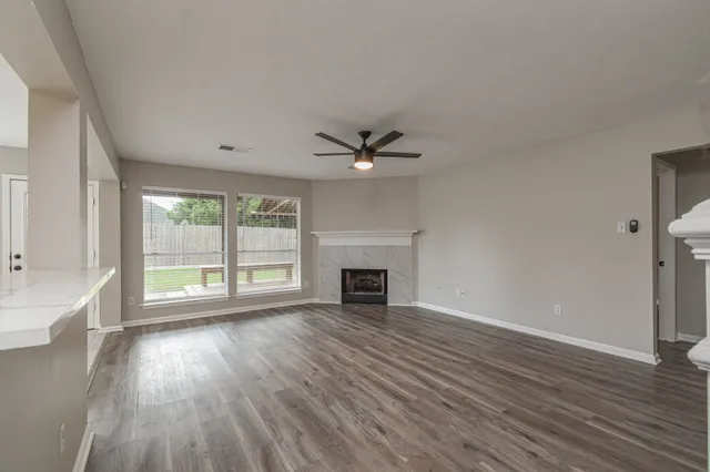 wooden floor in an empty room with a window