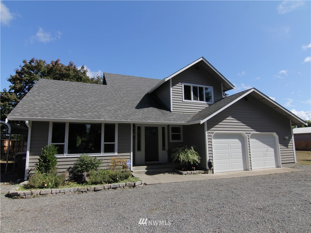 19002 Nutmeg Street Southwest Rochester, WA 98579 - Photo 1 of 19 a front view of a house with a yard and garage