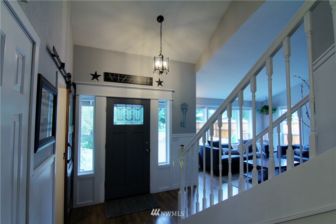 19002 Nutmeg Street Southwest Rochester, WA 98579 - Photo 2 of 19 a view of a hallway with dining area chandelier