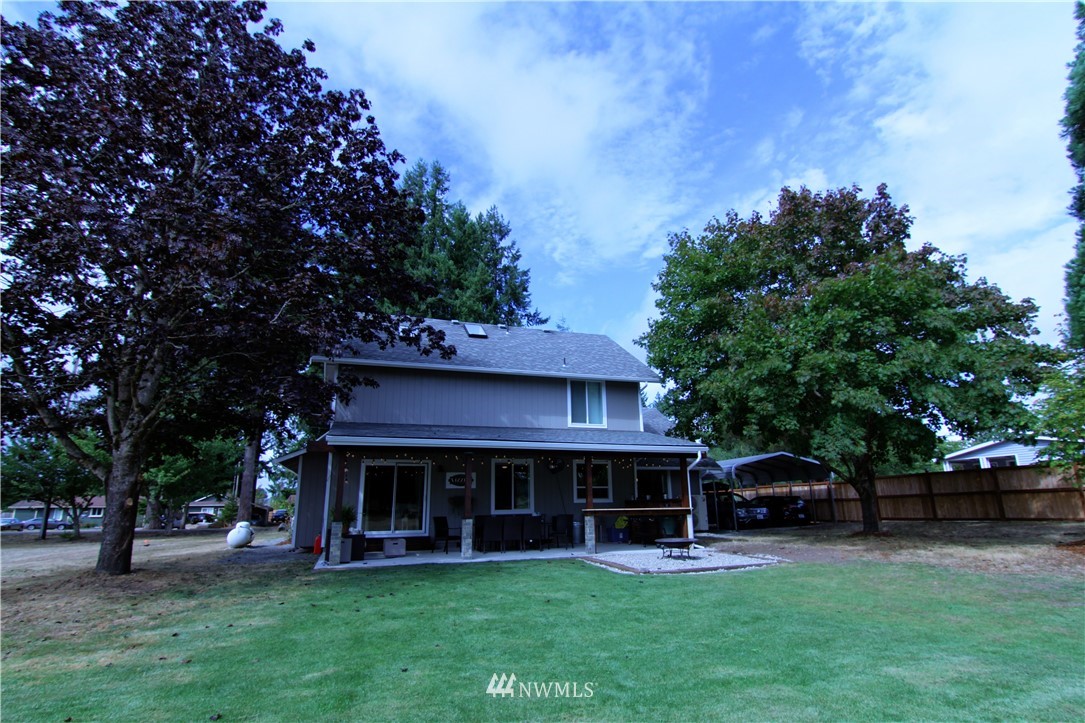 19002 Nutmeg Street Southwest Rochester, WA 98579 - Photo 15 of 19 a view of a house with a yard potted plants and a tree