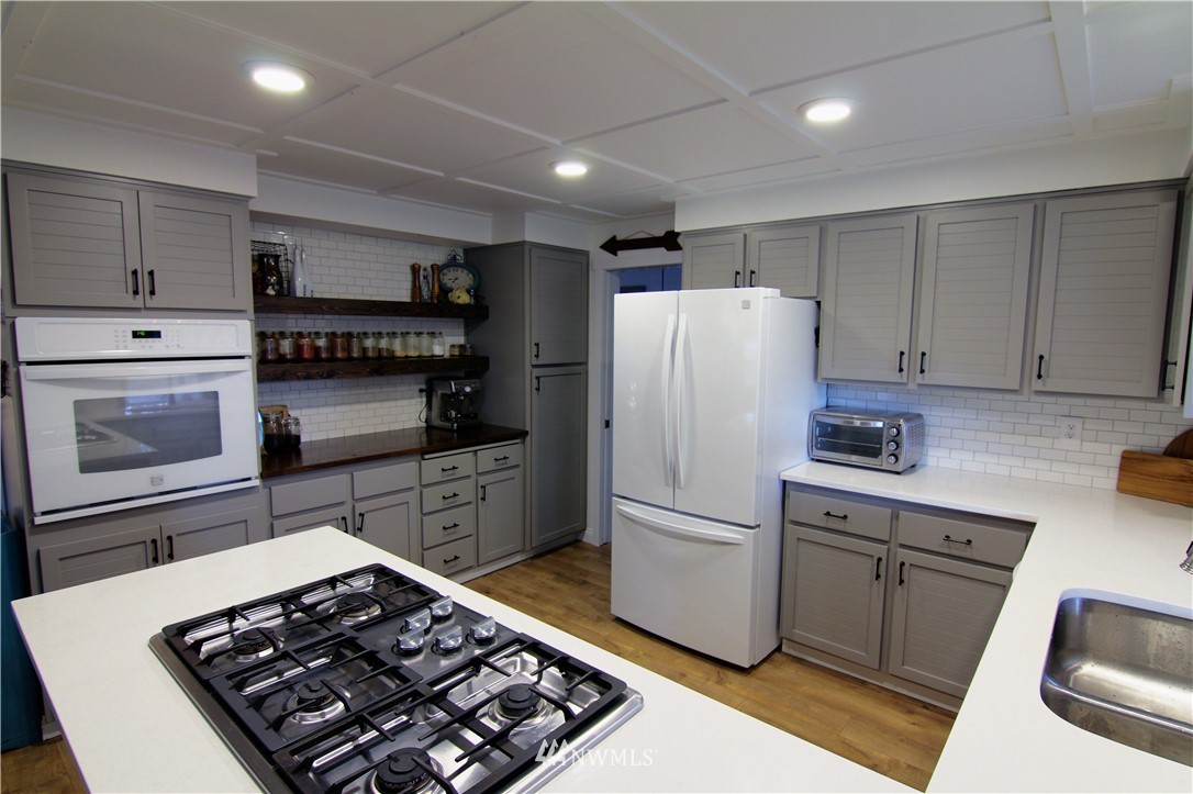 19002 Nutmeg Street Southwest Rochester, WA 98579 - Photo 4 of 19 a kitchen with refrigerator and stove