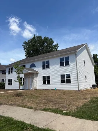 a view of a house with a backyard