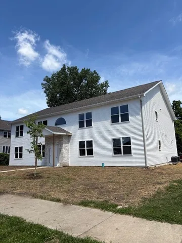 a view of a house with a backyard