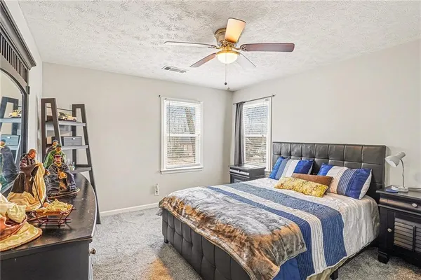 a bedroom with a bed and a desk