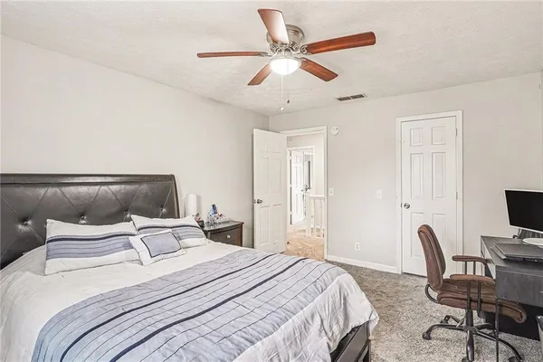 a living room with furniture a flat screen tv and a window