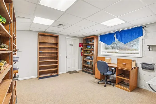 a living room with fireplace furniture and a chandelier