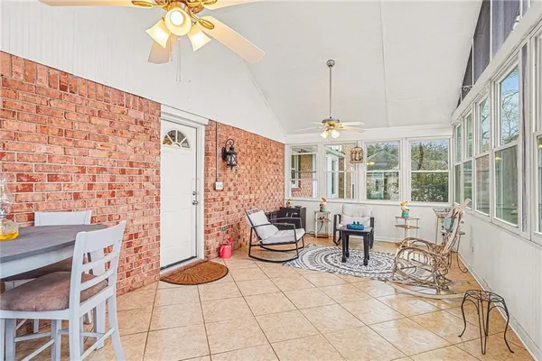 a view of a deck with wooden floor and fence with a floor to ceiling window
