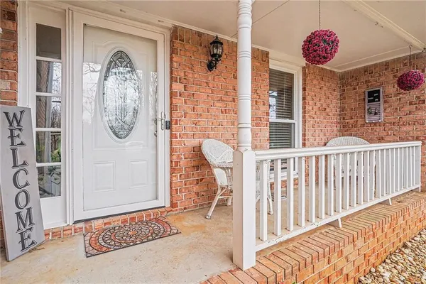 a kitchen with stainless steel appliances kitchen island granite countertop a table chairs and a refrigerator