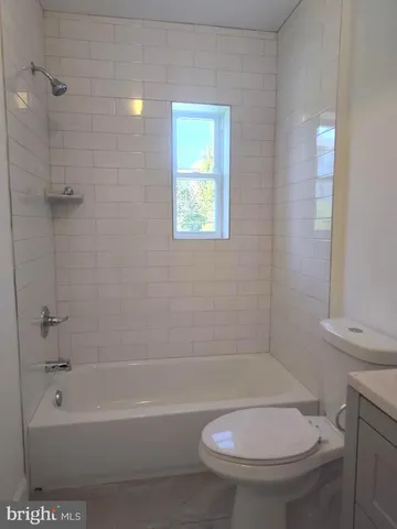 a bathroom with a toilet and a tub