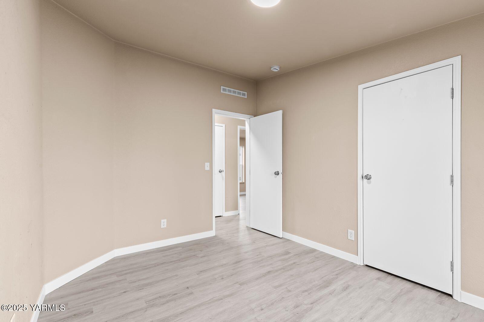 1023 Gibson Road Selah, WA 98942 - Photo 22 of 39 a view of an empty room with wooden floor