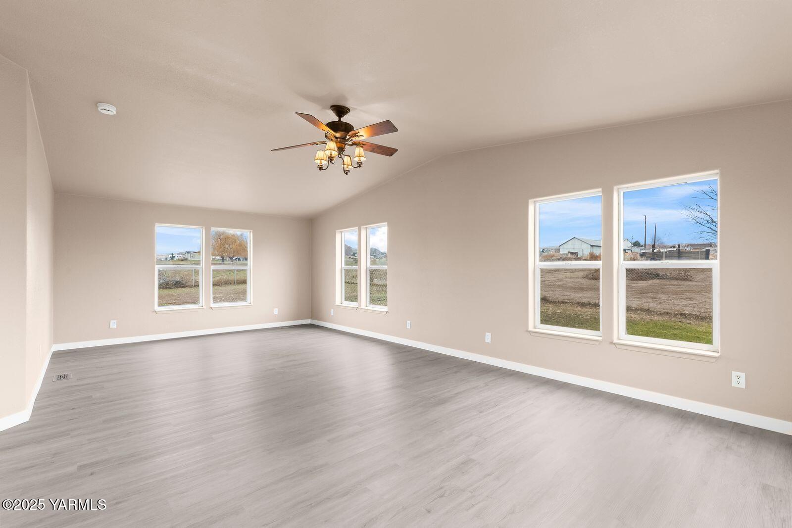 1023 Gibson Road Selah, WA 98942 - Photo 24 of 39 a view of an empty room with a window and wooden floor