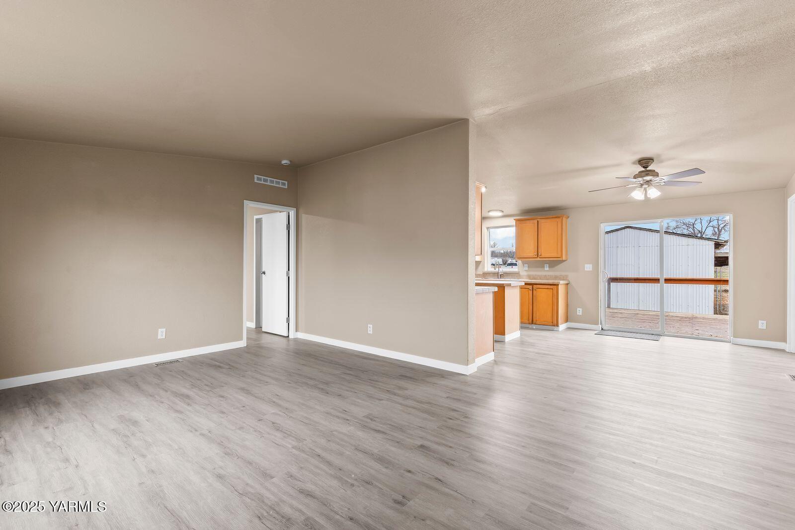 1023 Gibson Road Selah, WA 98942 - Photo 6 of 39 a view of an empty room with wooden floor and a window