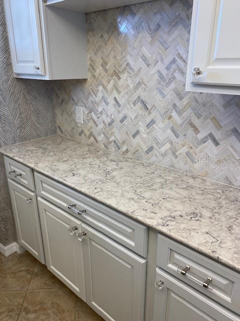 1 Boca Ciega Point Boulevard, Unit 213 St. Petersburg, FL 33708 - Photo 14 of 33 a view of a kitchen with white cabinets