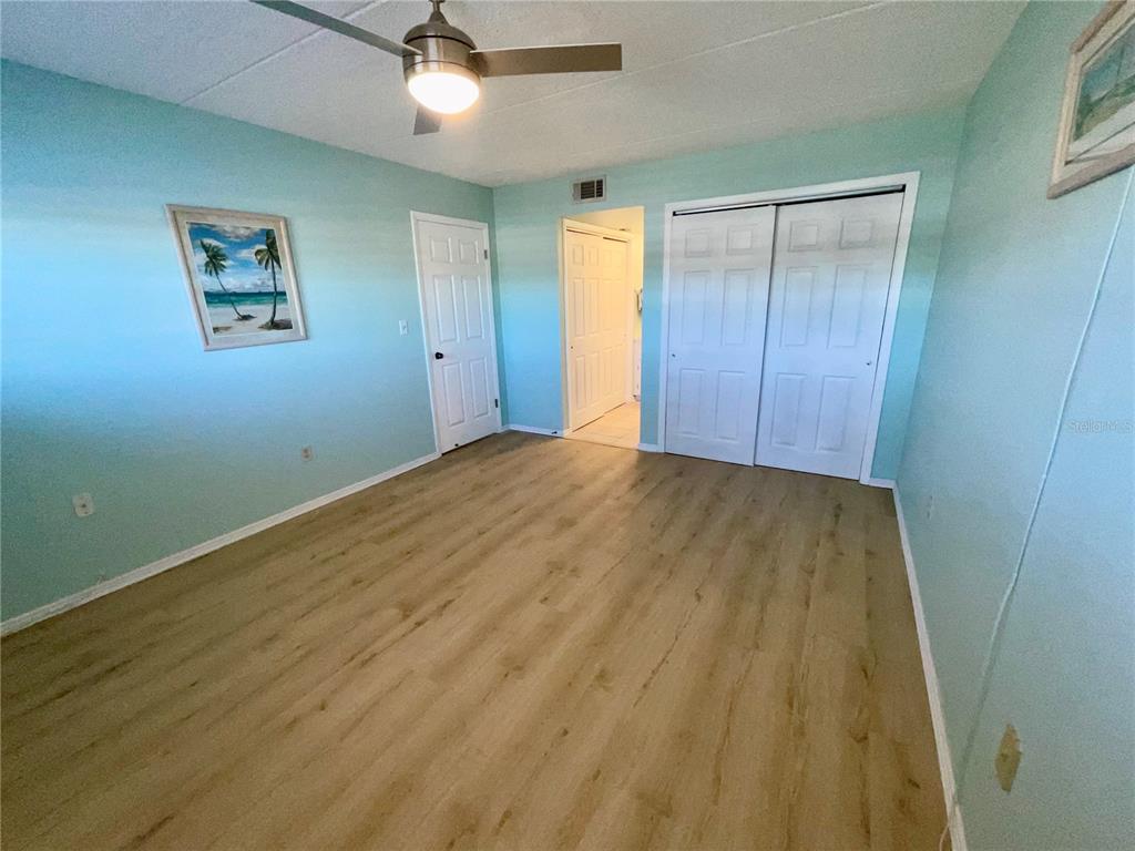 1 Boca Ciega Point Boulevard, Unit 213 St. Petersburg, FL 33708 - Photo 17 of 33 a view of room with wooden floor and ceiling fan