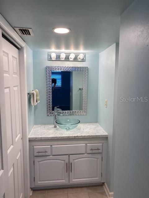 1 Boca Ciega Point Boulevard, Unit 213 St. Petersburg, FL 33708 - Photo 19 of 33 a bathroom with a sink and a mirror