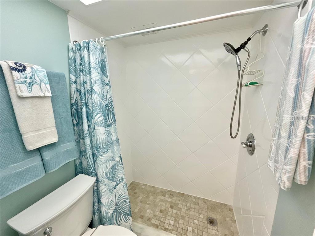1 Boca Ciega Point Boulevard, Unit 213 St. Petersburg, FL 33708 - Photo 22 of 33 a bathroom with a shower toilet and sink