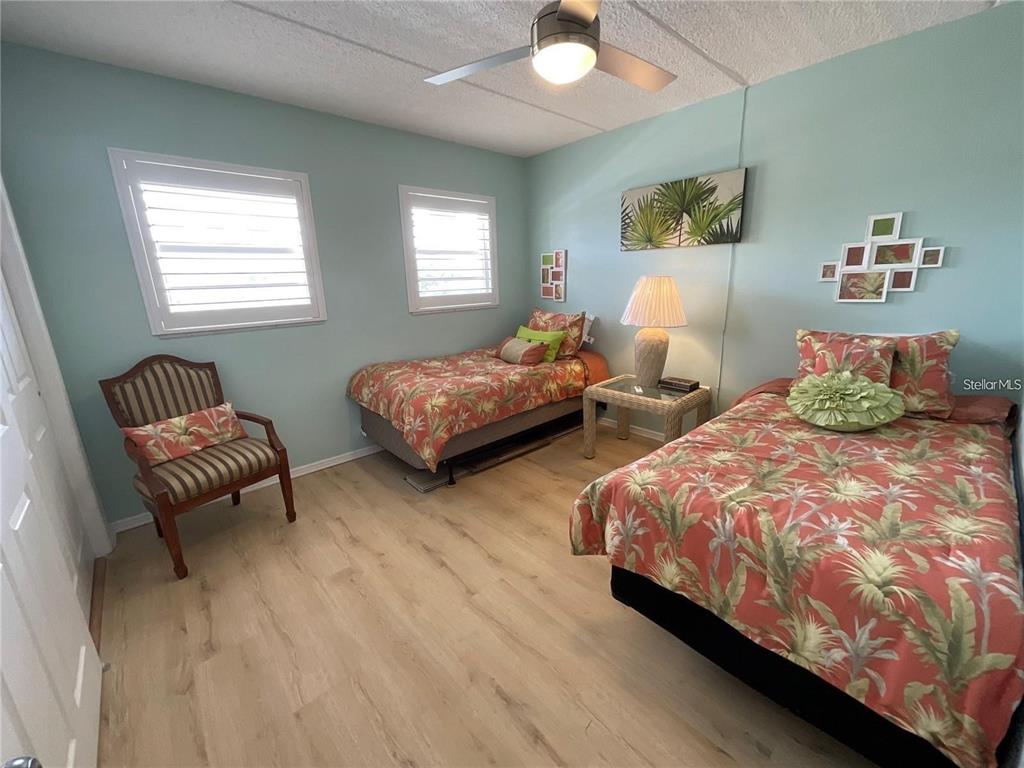 1 Boca Ciega Point Boulevard, Unit 213 St. Petersburg, FL 33708 - Photo 23 of 33 a bedroom with two beds and a couch