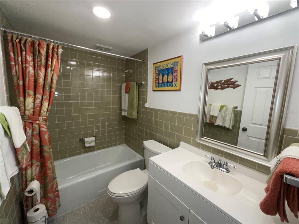 1 Boca Ciega Point Boulevard, Unit 213 St. Petersburg, FL 33708 - Photo 26 of 33 a bathroom with a sink toilet and shower