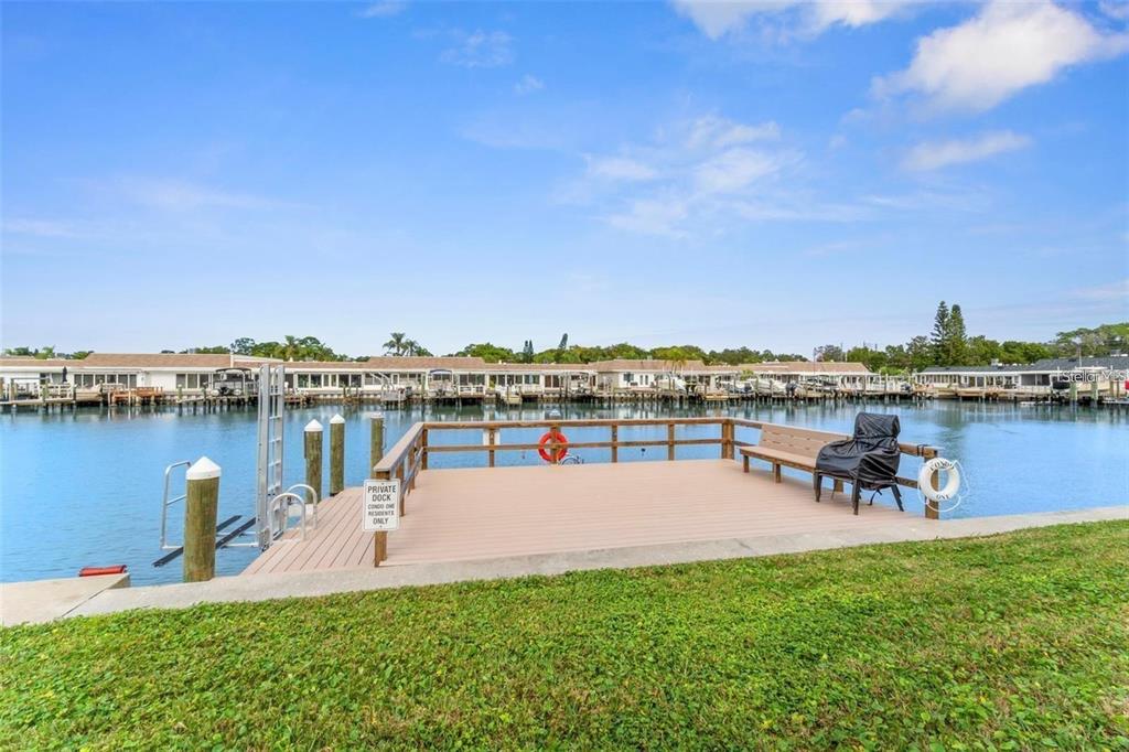 1 Boca Ciega Point Boulevard, Unit 213 St. Petersburg, FL 33708 - Photo 30 of 33 a view of a lake with houses in the back