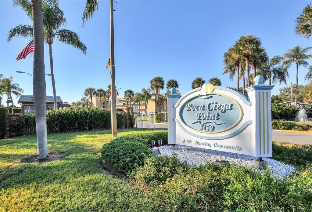 1 Boca Ciega Point Boulevard, Unit 213 St. Petersburg, FL 33708 - Photo 32 of 33 a view of a park with palm trees and sign board