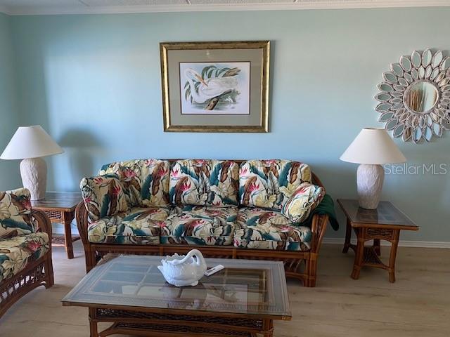 1 Boca Ciega Point Boulevard, Unit 213 St. Petersburg, FL 33708 - Photo 6 of 33 a living room with furniture and a lamp
