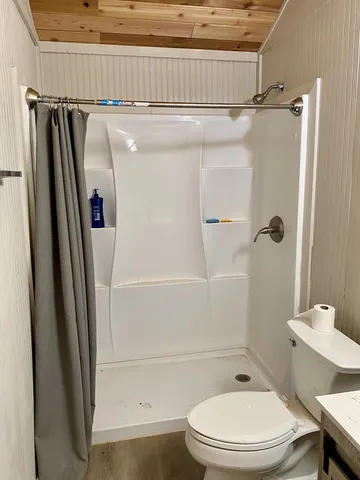 a bathroom with a toilet and a shower