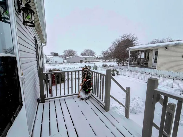 a view of a house with wooden deck