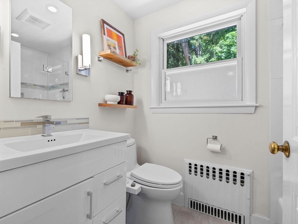 33 Pond Circle Boston, MA 02130 - Photo 18 of 22 a bathroom with a toilet a sink and a window