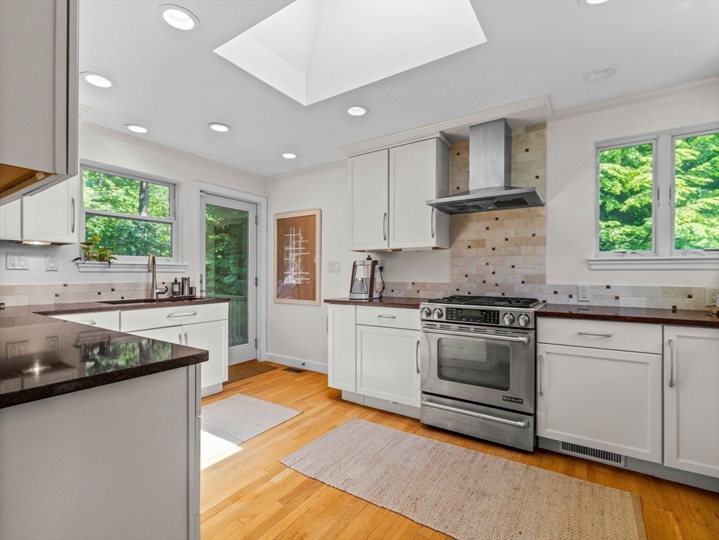 33 Pond Circle Boston, MA 02130 - Photo 8 of 22 a kitchen with stainless steel appliances granite countertop a stove a sink and a microwave