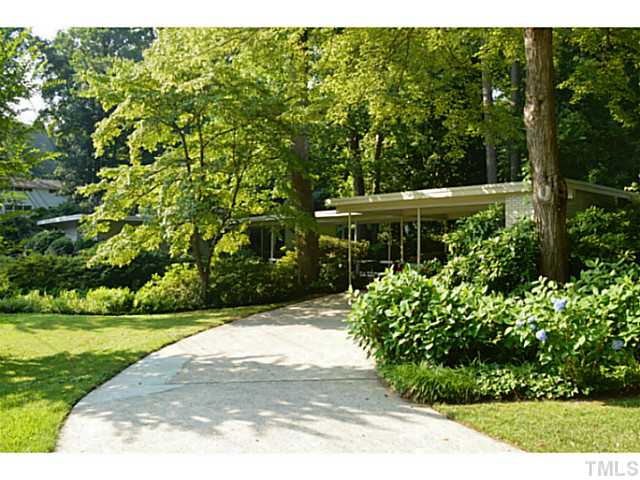 3700 Swann Street Raleigh, NC 27612 - Photo 2 of 20 Hidden from the street, the mid-century house features a circular drive and double carport with storage.