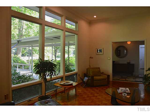 3700 Swann Street Raleigh, NC 27612 - Photo 4 of 20 Parquet floors and floor to ceiling windows can be found throughout the home, and are a very striking feature upon entry.