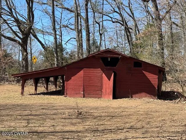 a view of dirt yard with a tree