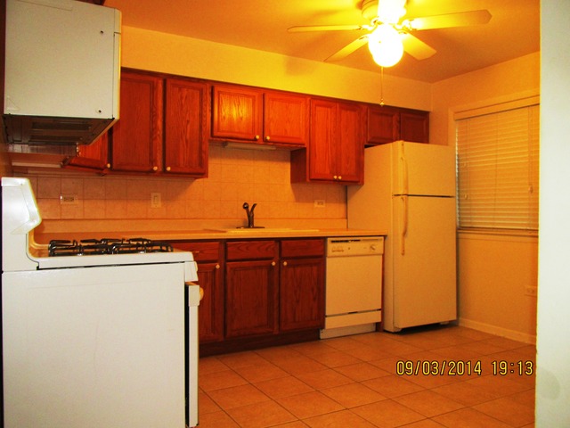 8808 45th Place, Unit 2 Brookfield, IL 60513 - Photo 4 of 10 a kitchen with a refrigerator and cabinets