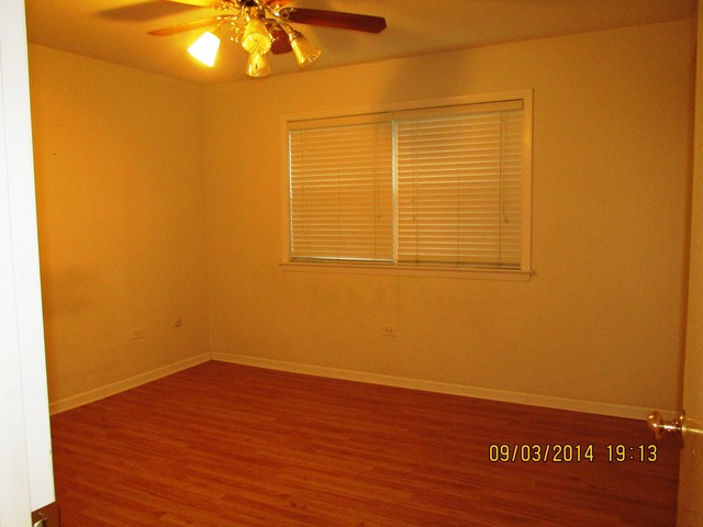 8808 45th Place, Unit 2 Brookfield, IL 60513 - Photo 7 of 10 a view of a room with wooden floor and fan