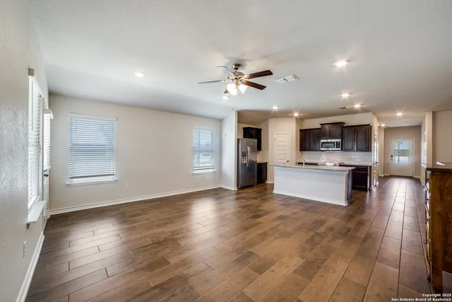 a view of kitchen with stove and cabinets