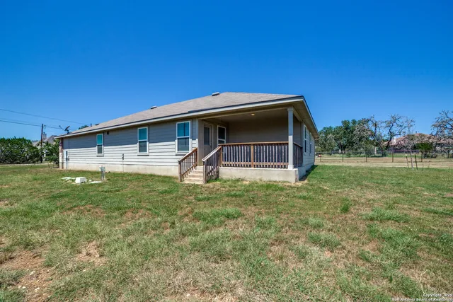 a backyard of a house with lots of green space