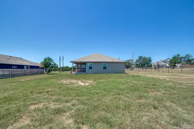 a view of a house with a yard and sitting area