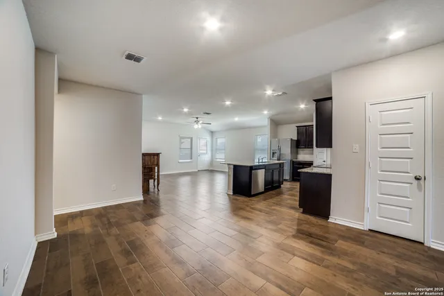 a view of kitchen with kitchen island sink refrigerator and stove