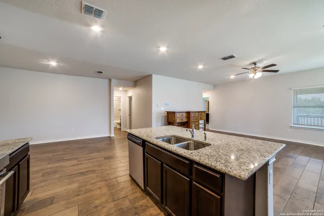 a kitchen with granite countertop cabinets a sink and dishwasher
