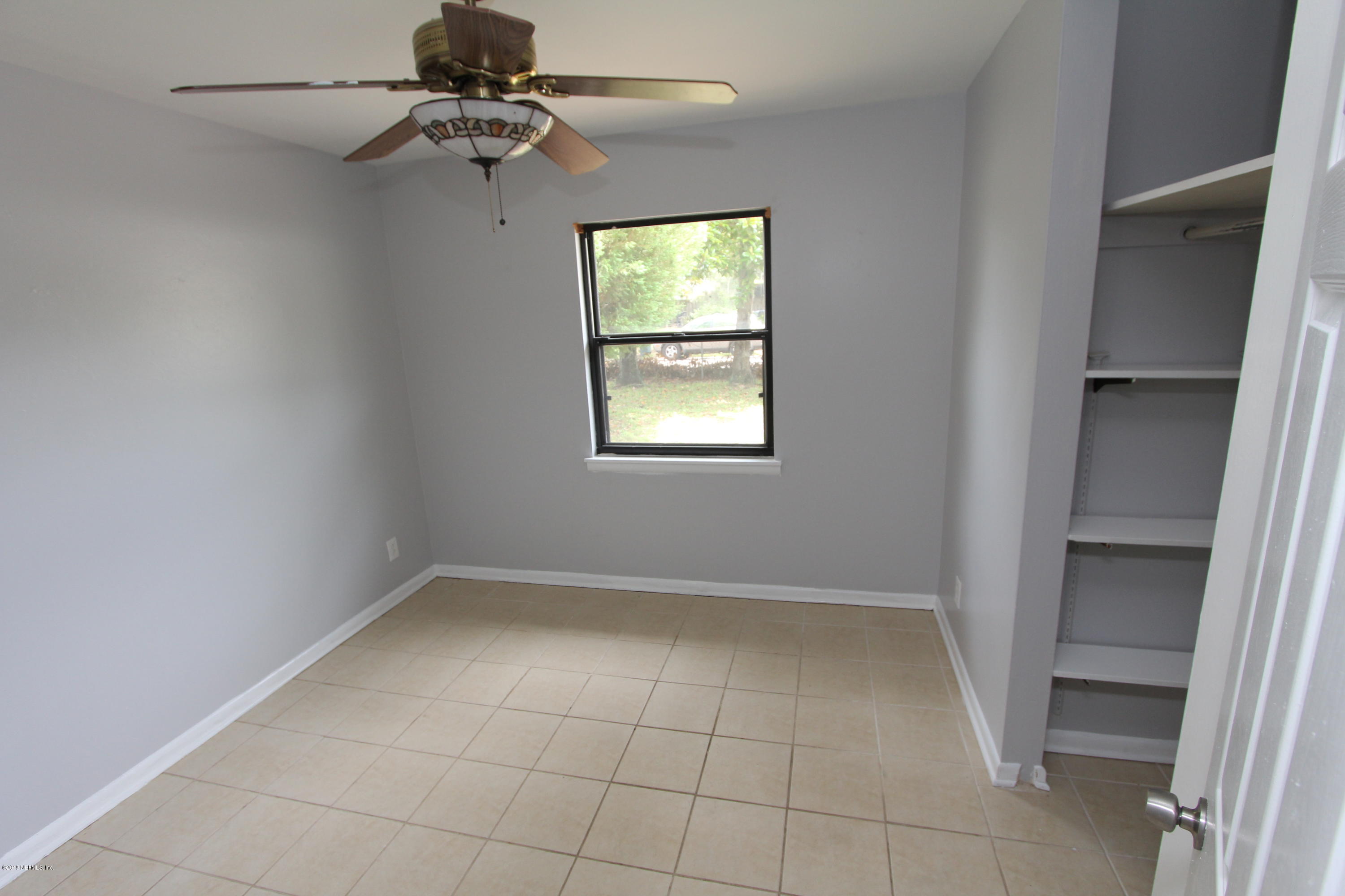 10610 Dodd Road Jacksonville, FL 32218 - Photo 12 of 24 an empty room with windows and fan