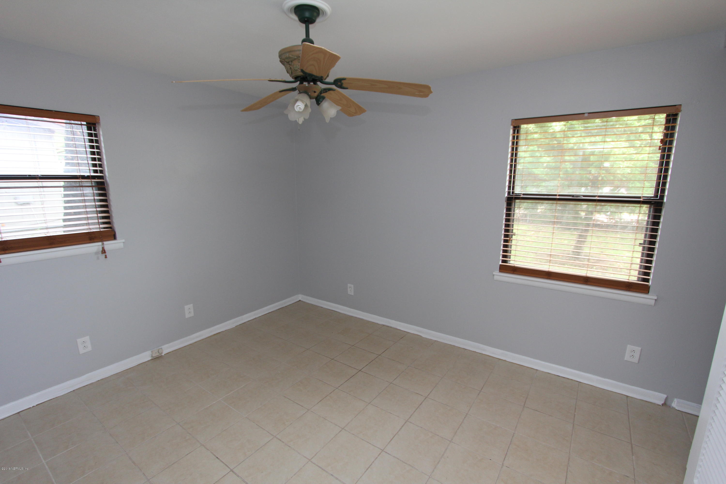 10610 Dodd Road Jacksonville, FL 32218 - Photo 13 of 24 a view of an empty room with a window