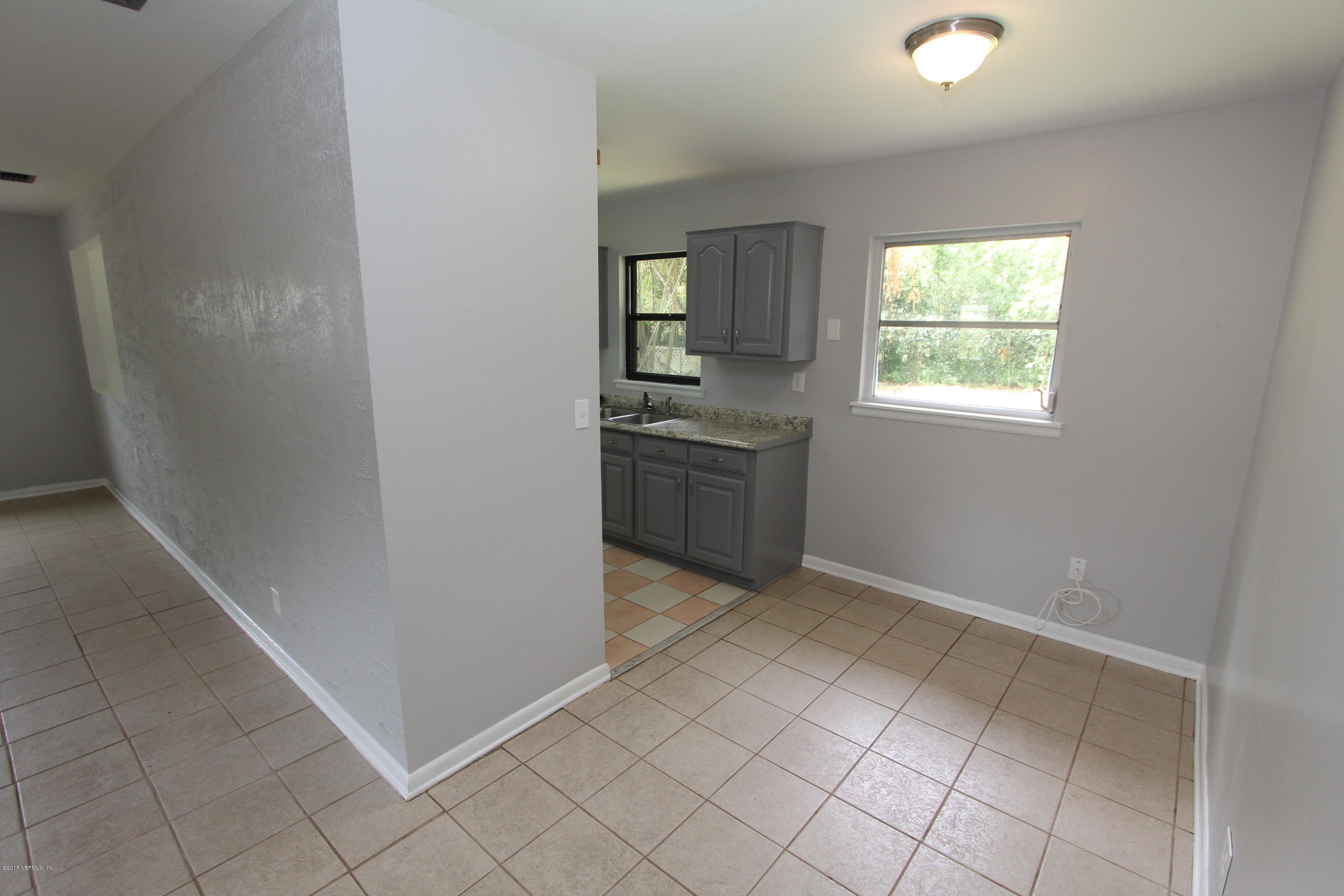 10610 Dodd Road Jacksonville, FL 32218 - Photo 5 of 24 an empty room with windows