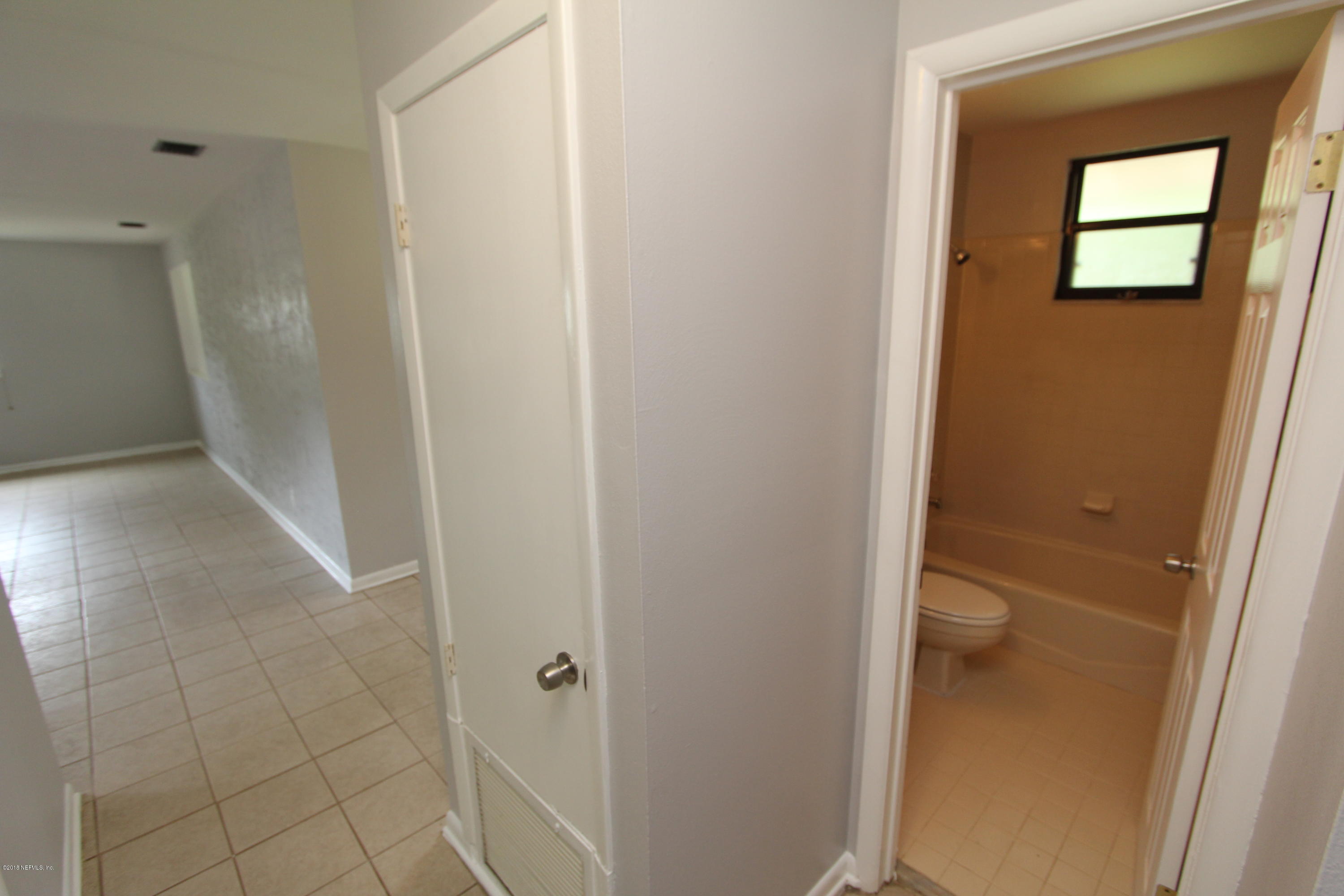 10610 Dodd Road Jacksonville, FL 32218 - Photo 9 of 24 a view of a bathroom from a hallway