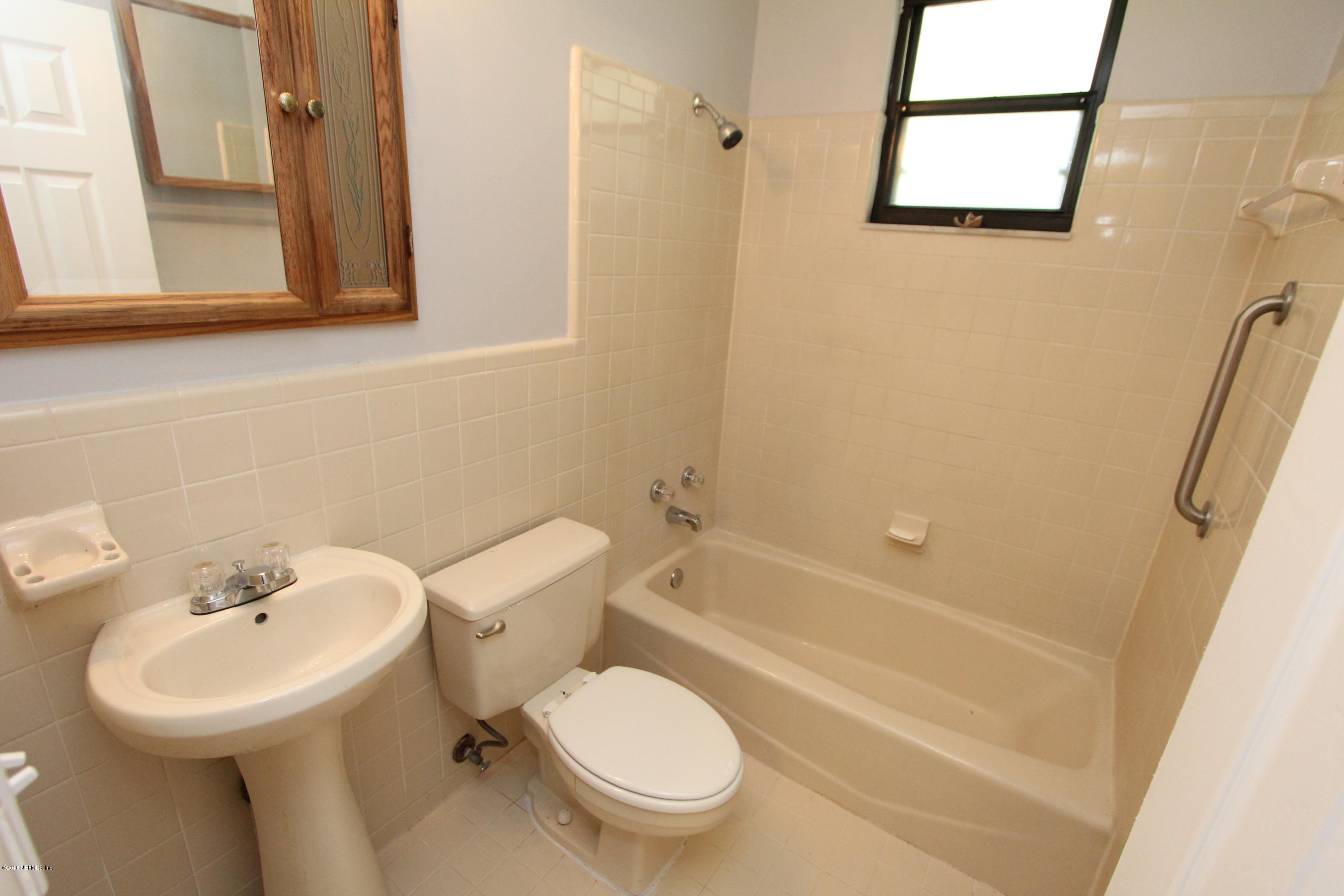 10610 Dodd Road Jacksonville, FL 32218 - Photo 10 of 24 a bathroom with a sink toilet and shower
