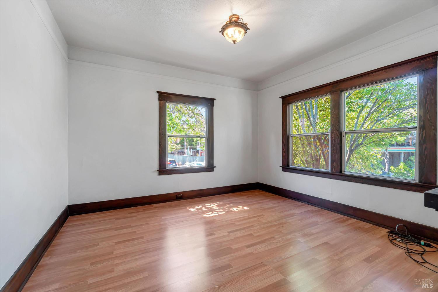 7 Bayview Street San Rafael, CA 94901 - Photo 12 of 79 an empty room with wooden floor and windows