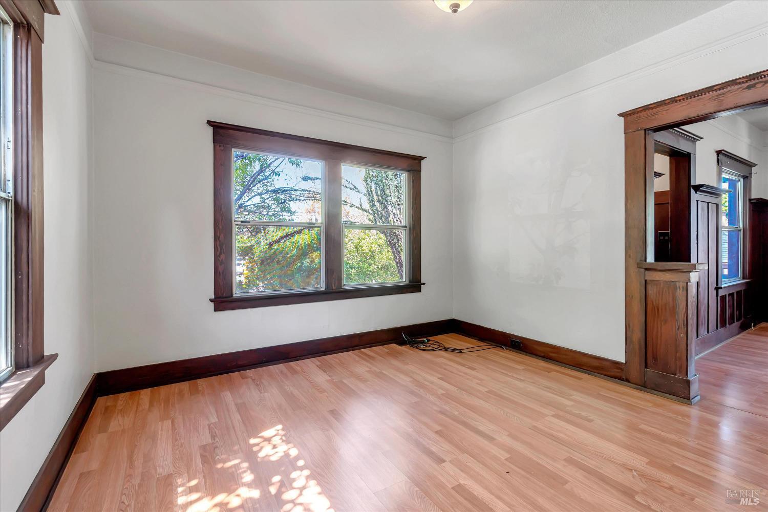 7 Bayview Street San Rafael, CA 94901 - Photo 13 of 79 a view of an empty room with wooden floor and a window