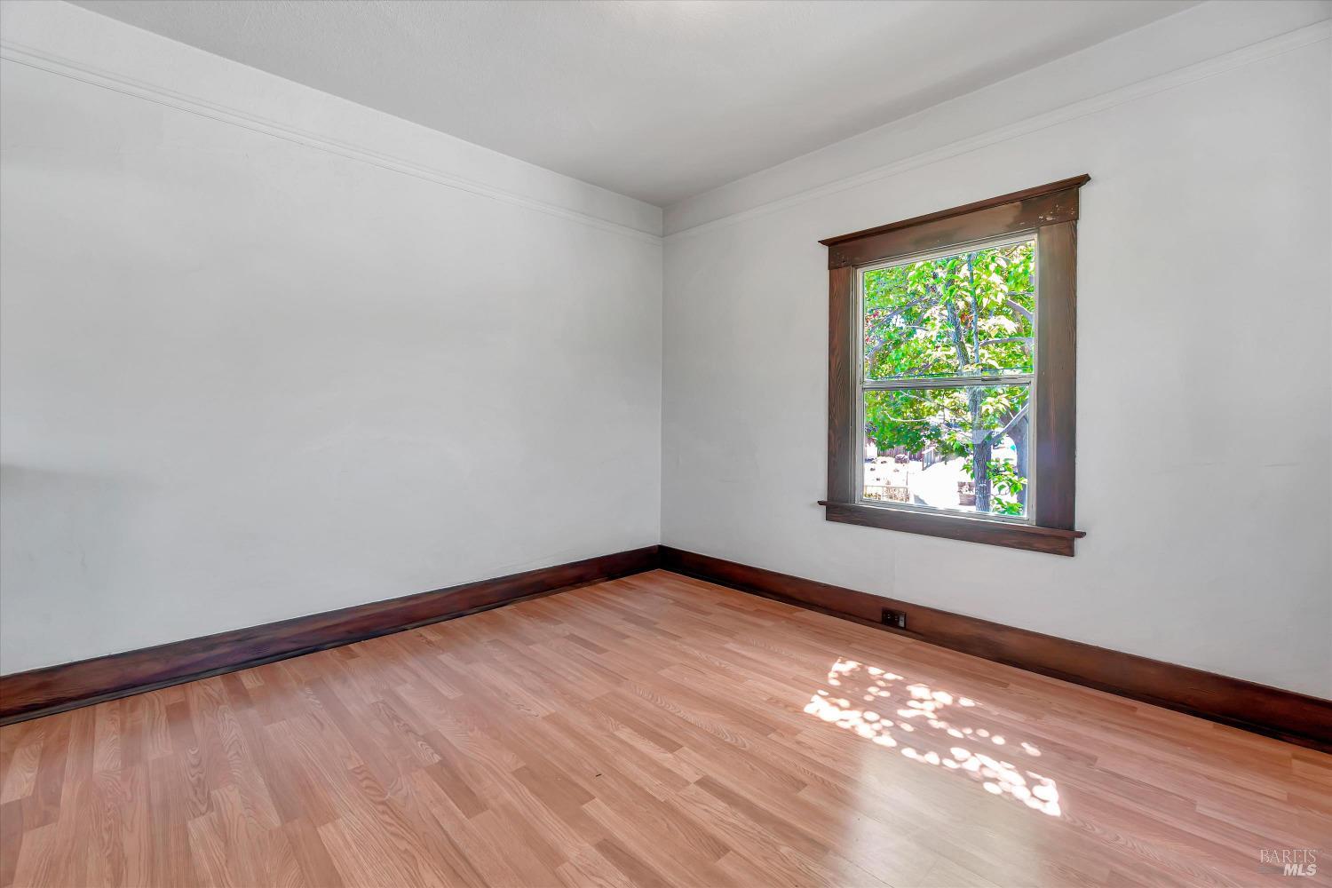 7 Bayview Street San Rafael, CA 94901 - Photo 15 of 79 a view of an empty room with wooden floor and a window