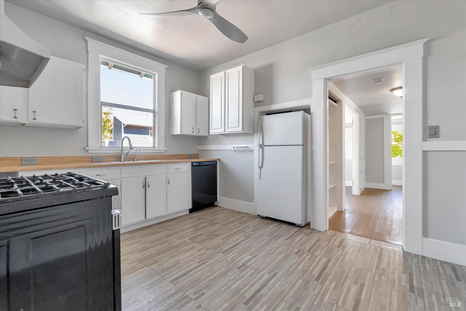 7 Bayview Street San Rafael, CA 94901 - Photo 17 of 79 a kitchen with a refrigerator a sink and wooden floor