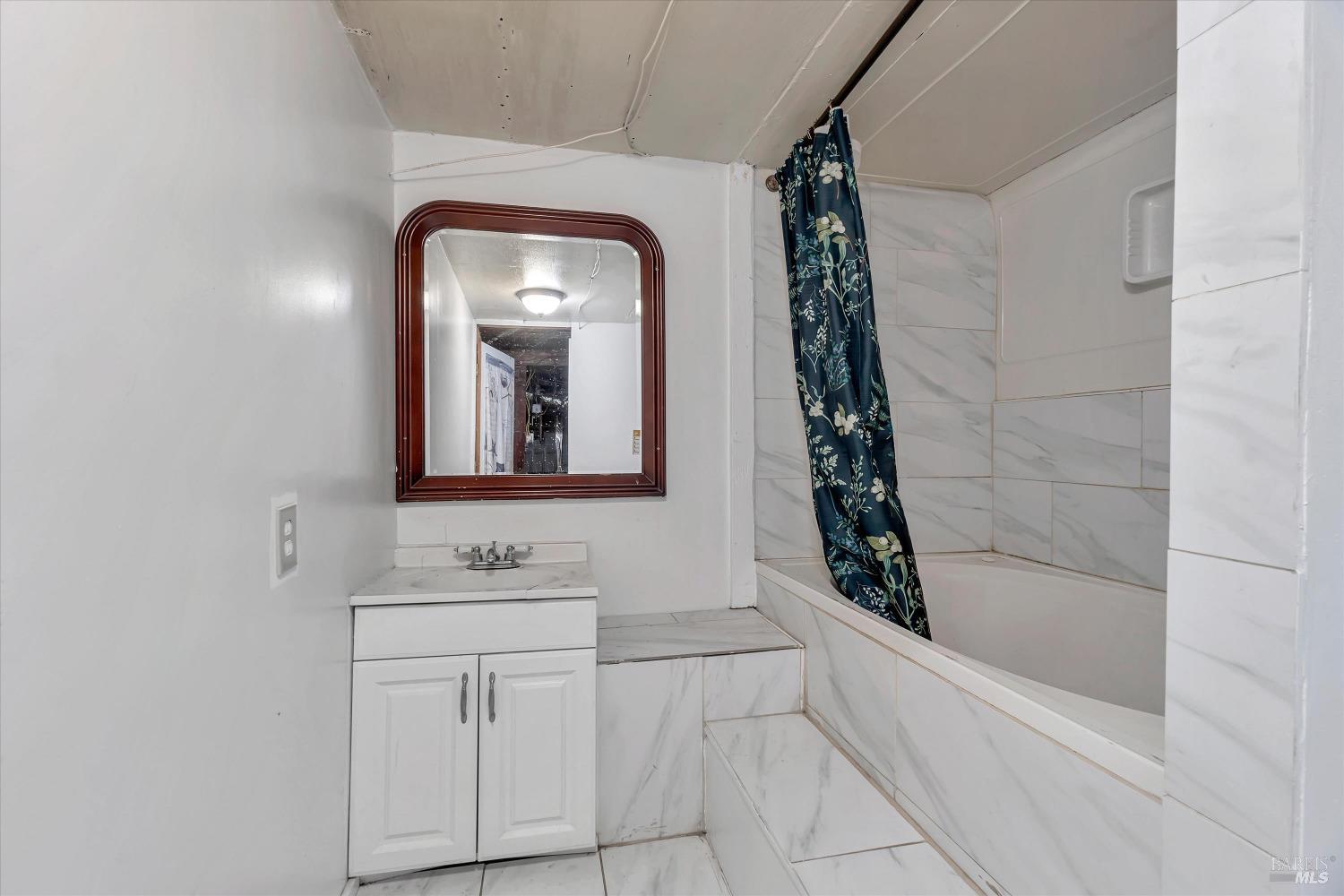 7 Bayview Street San Rafael, CA 94901 - Photo 44 of 79 a bathroom with a sink a vanity and a mirror