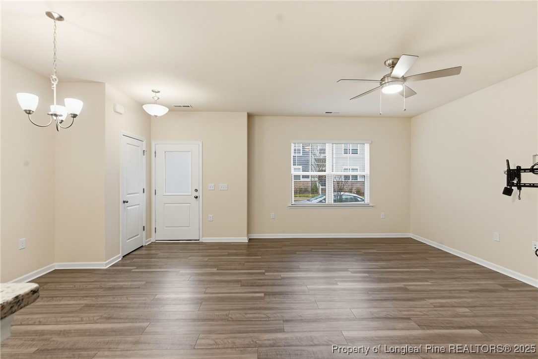 245 Ribbon Rail Street Fuquay-Varina, NC 27526 - Photo 11 of 43 a view of an empty room with wooden floor and a window